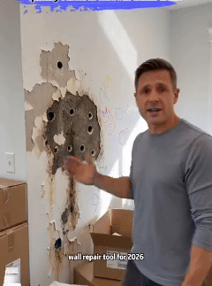 A man shows the wall repair applicator